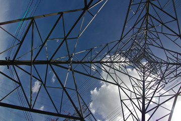 electricity pylon against blue sky