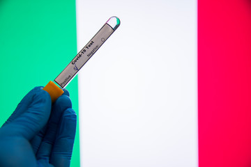 Coronavirus or Covid-19 in Italy, sample blood tubes in hand Italy flag on background, Blood sample with COVID-19 Coronavirus Chinese infection Italy