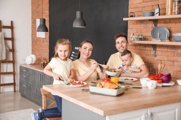 Young family having dinner in kitchen