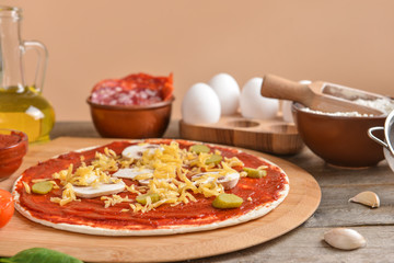 Preparing of tasty pizza on table