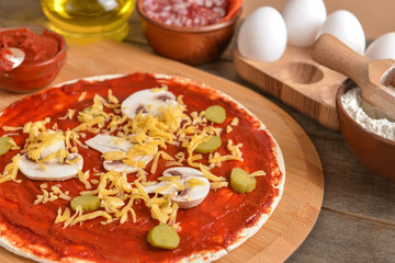 Preparing of tasty pizza on table