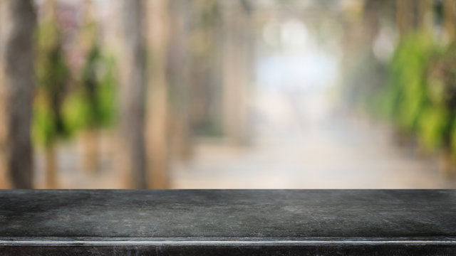 Empty Black Marble Stone Table Top And Blurred Green Tree And Vegetable In Greenhouse Of Agricultural Farms. Background - Can Used For Display Or Montage Your Products.