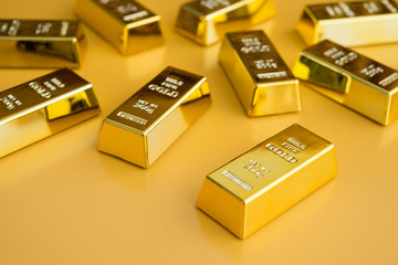 Gold bars or bullion on yellow background. Financial, global world economic or gold trading in...