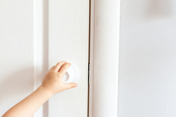 The child opens the door. Or the child's hand opens the door by the handle.