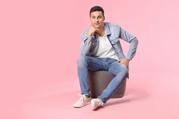 Portrait of young man on color background © Pixel-Shot