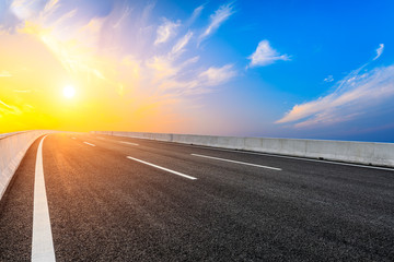 Asphalt highway road and sky sunset clouds landscape.