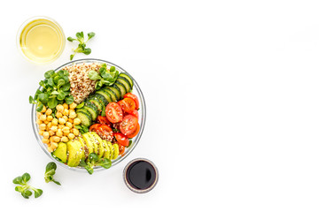 Vegan bowl. Avocado, quinoa, tomato, spinach and chickpeas vegetables salad on white table top-down copy space