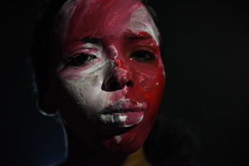 Beauty model girl with colorful paint on her face