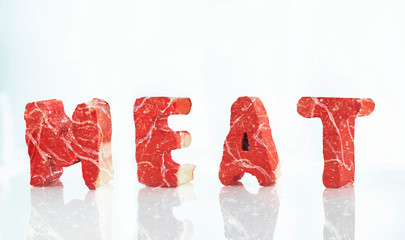 Word meat. Three-dimensional letters from meat on a white background 