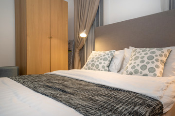 queen size bed with bed runner and reading lamp in villa, house and apartment