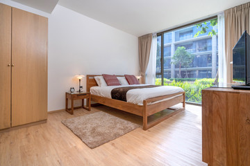 queen size bed with bed runner and reading lamp in villa, house and apartment