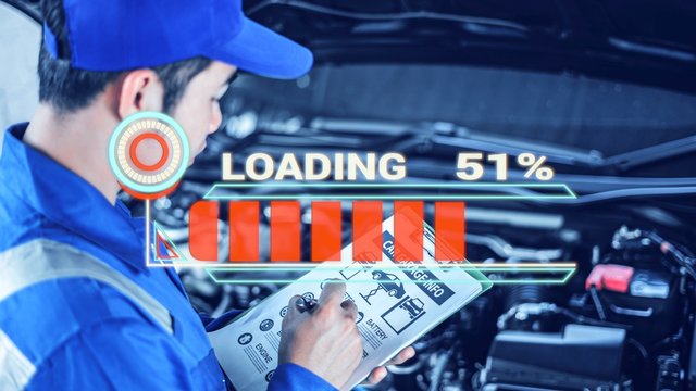 male Asian car mechanic using a computer laptop to diagnosing and checking up on car engines parts for fixing and repair, Loading energy car