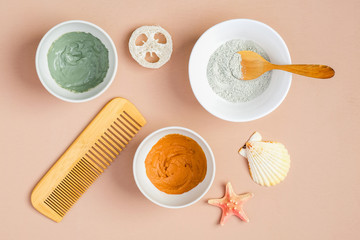 Clay masks and SPA cosmetic products on peach background. Natural SPA cosmetics for skincare, body and hair care concept. Flat lay, top view