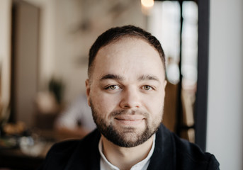 Obraz premium Portrait of fashionable well dressed man with beard posing outdoors