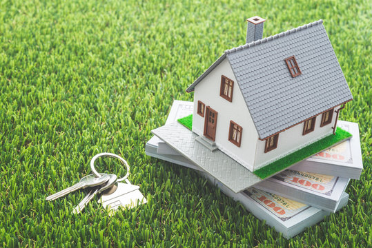 House Model, Bill Dollar Banknotes And Key On Green Artificial Grass Background. Money Saving For New House, Home Loan, Reverse Mortgage And Real Estate Property Business Concept