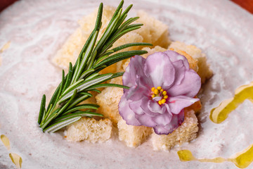 Delicious beautiful mushroom soup in a brown plate with a wooden spoon