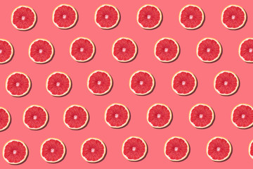 Fresh red orange or grapefruit on a peach color background.