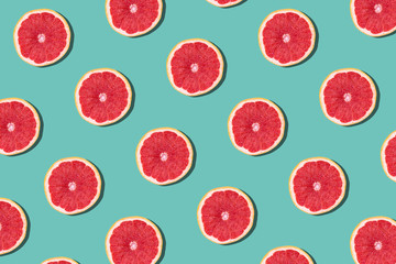 Tasty ripe grapefruit slices on blue background