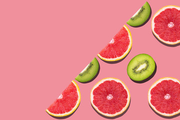 Seamless pattern with juicy kiwi and greapfruit on pink background.