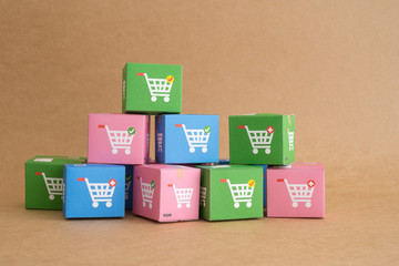 Color carton boxes with drawing of trolley or shopping cart. Ecommerce, online shopping, COD (Cash...