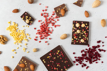 Raw Vegan Handmade Chocolate with nuts and dried fruits. Milk and dark chocolate bars on white...