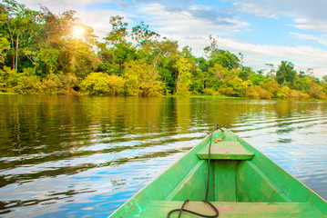 Traditional wooden boat floats on the Amazon river in the jungle. Amazon River Manaus, Amazonas, Brazil.
