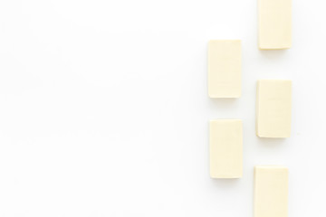 Soap bars flat lay on white background top-down copy space frame