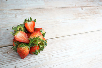 Fresh organic strawberry on top of wooden table