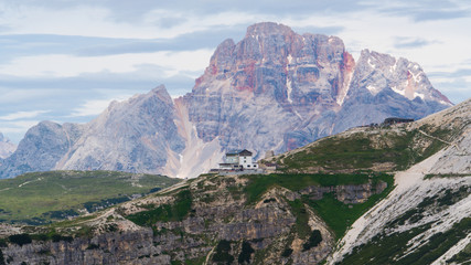 A house on hillside; dolomite rocks in Italy