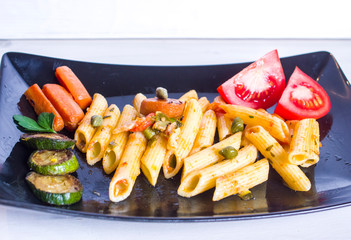 pasta with colorful and nutritious vegetables and with capers