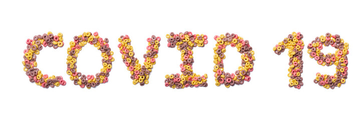 Inscription Covid 19 of the English alphabet  from pink colored flakes on a white isolated background.Sign  coronavirus from a photo of  sweet breakfast cereals