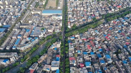 Aerial view of city buildings and roads in early morning sunlight, China