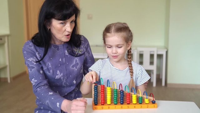 a teacher with girl learning to add and subtract