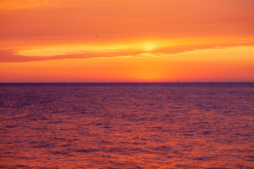 beautiful red-orange sunset on the sea, colorful sky and sea, magical landscape