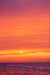 Naklejka na ściany i meble beautiful red-orange sunset on the sea, colorful sky and sea, magical landscape