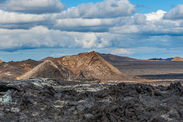 Beautiful colourful Icelandic landscape lava fields mountain geysers zigzag road and moss-covered stones Namafjall, Iceland.