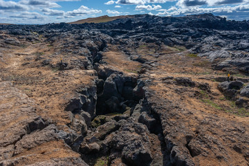 Beautiful colourful Icelandic landscape lava fields mountain geysers zigzag road and moss-covered...