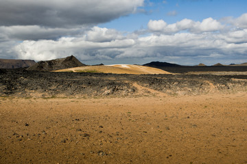 Beautiful colourful Icelandic landscape lava fields mountain geysers zigzag road and moss-covered stones Namafjall, Iceland.