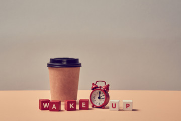 Waking up. Morning coffee. Start new day. Stop sleeping. Wake up inscription. Alarm clock, paper...