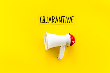 Quarantine announcement in world. Megaphone on yellow background top view