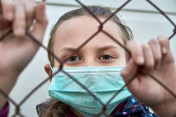 A girl in a medical mask. Quarantine. A girl in the quarantine zone. Coronavirus concept. Girl wearing protective mask.
