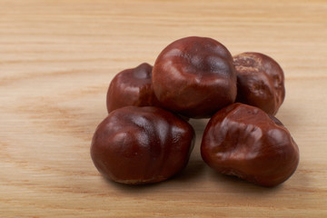 Chestnuts. Buckeye. Autumn mood. Sweet chestnuts on a wooden background.