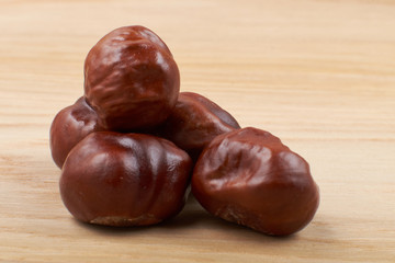 Chestnuts. Buckeye. Autumn mood. Sweet chestnuts on a wooden background.