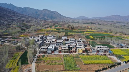 Fototapeta na wymiar Aerial view of Chinese countryside, houses in farmland, hills 