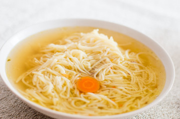 Bowl of broth noodle soup..