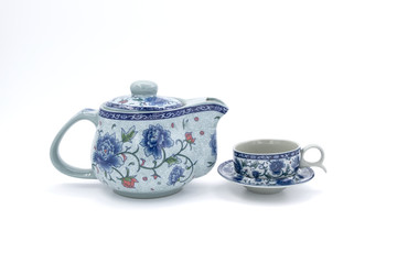 cup with tea and teapot on white  background, over light