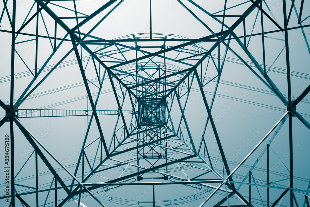 Wall mural abstract pattern from bottom view of high voltage pole power transmission tower with clear sky sunny