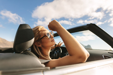 Woman on a road trip driving in car