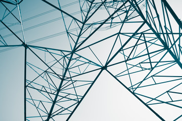 Abstract pattern from bottom view of high voltage pole power transmission tower with clear sky...