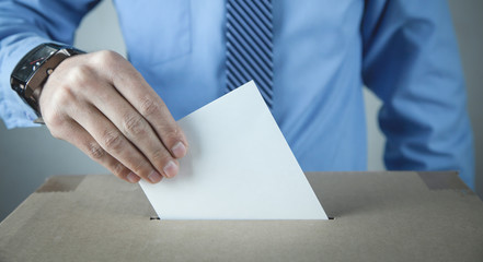 Man putting ballot in election box. Democracy. Freedom